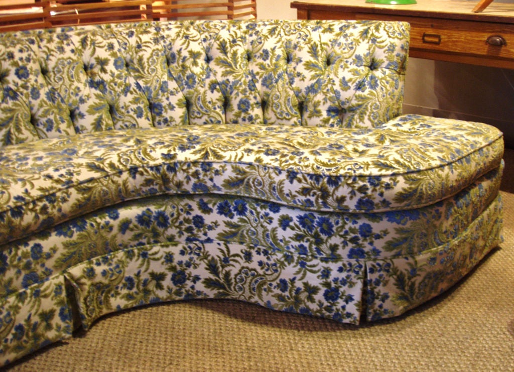 a stunning vintage 1960's Hollywood Regency sofa having a gracefully curved & armless end and a fully burron tufted back. great lines and very comfortable. in its original floral upholstery
