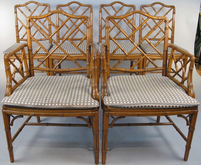 a very charming set of six vintage 1960's faux bamboo dining chairs. 4 armless side chairs and a pair of armchairs. beautiful details and very well made with cane seats and upholstered seat cushions in their original faux caning fabric.