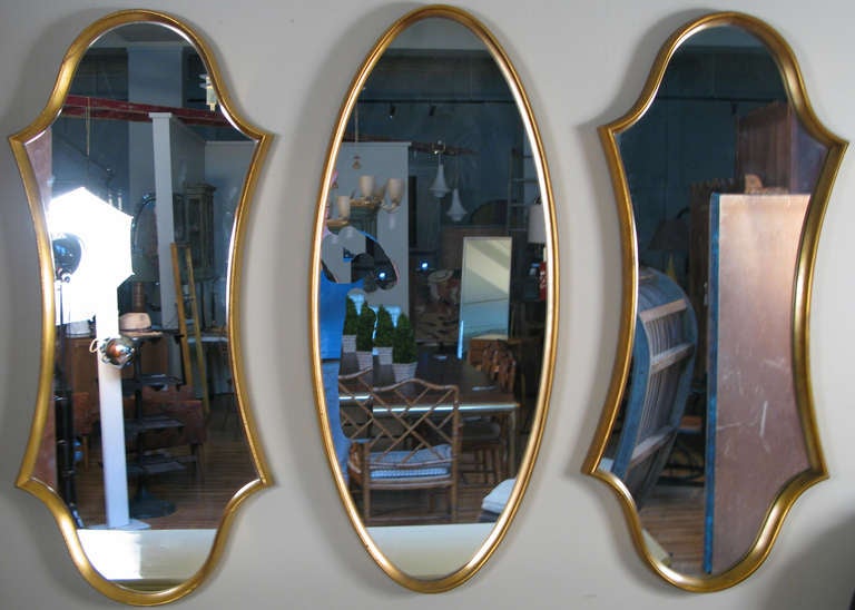 a selection of vintage 1960's sculptural mirrors with gold leaf frames by La Barge. hourglass and oval forms available. priced individually.