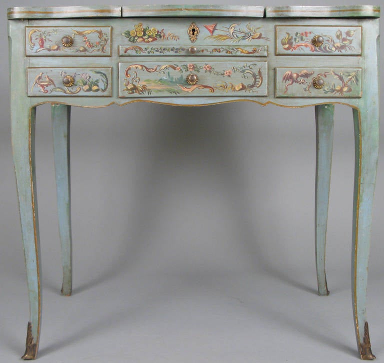 A hand-painted 1920s chinoiserie vanity with hinged mirror top and padded and upholstered storage compartments and two drawers as well as a leather covered slide out tray.