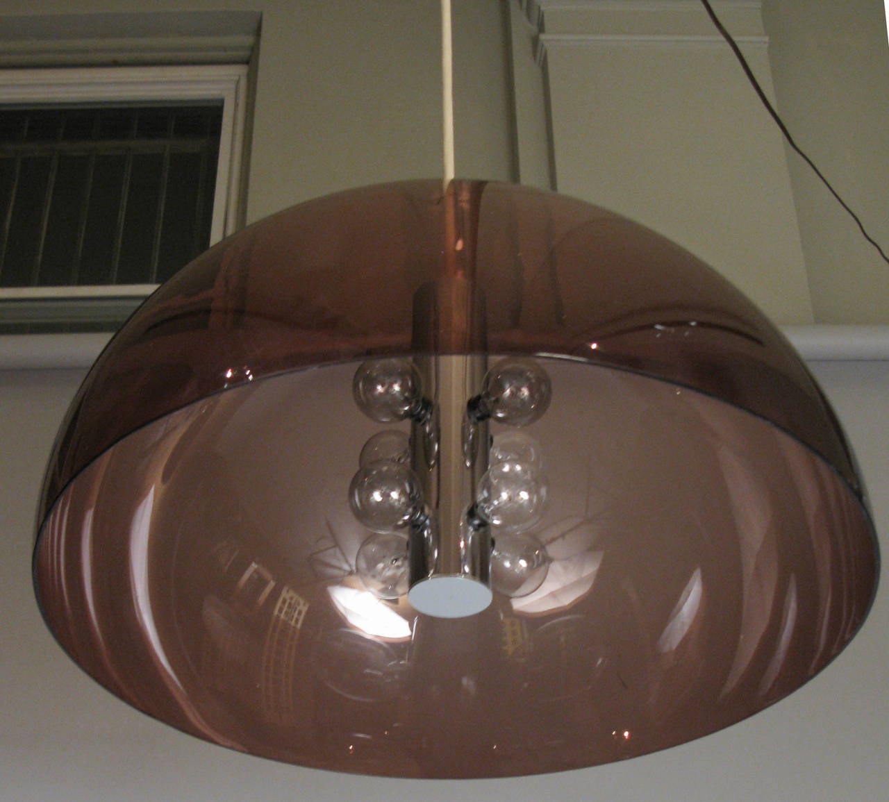 a vintage 1960's hanging light fixture by Lightolier with a center core of crome with 8 bulb sockets, and a thick plastic dome of pale purple. great size and scale. signed Lightolier.