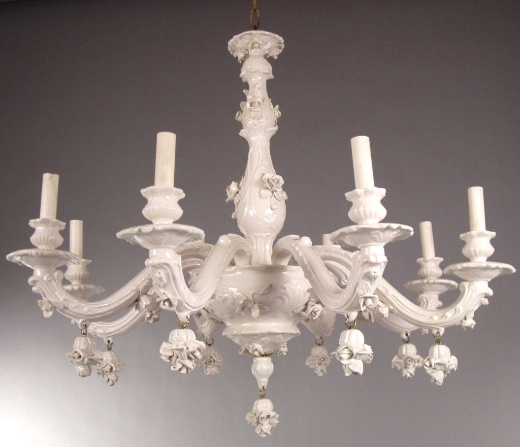 an outstanding vintage 1960's Blanc de Chine Italian porcelain 8 light chandelier. this beautiful fixture has 8 gracefully curved arms, and is highlighted with decorative roses, as well as hanging roses from the arms. also has a matching porcelain