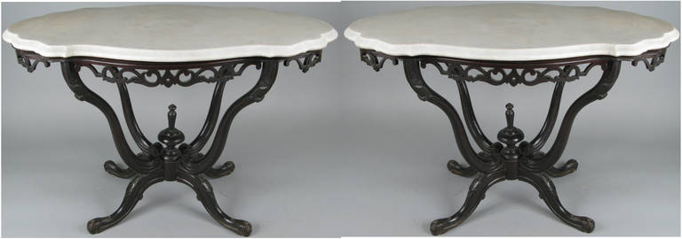 A beautiful pair of Anglo-Indian mahogany tables with carved and ebonized bases and the original serpentine marble tops. Attributed to cabinet maker B. W. Lazarus who was working in India in the mid to late 19th century.