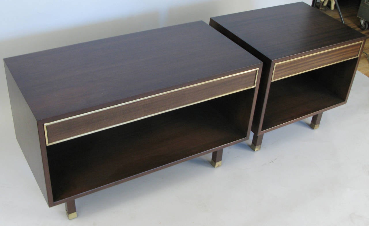 A pair of vintage 1960s mahogany nightstands by Harvey Probber, with a single drawer each and open storage below. With brass sabots and trim around the drawer. 

Dimensions: Smaller cabinet is: 24 W x 18 D x 23 H.
Longer cabinet is: 36 W x 18 D x