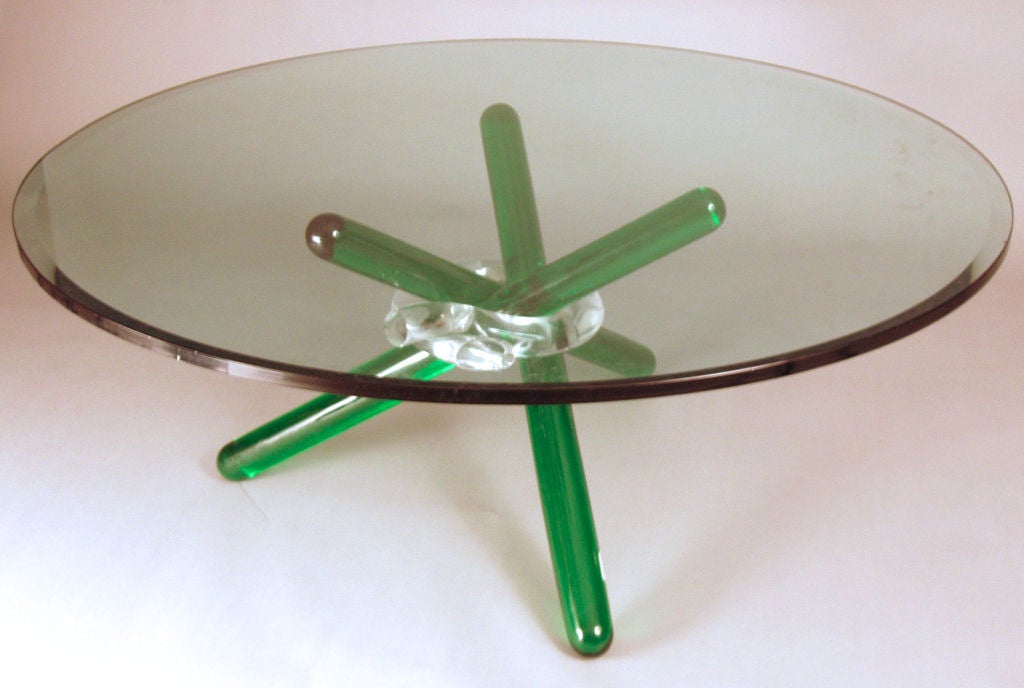 a beautiful French Cocktail table by Maurice Barilone. An engaging and unique design all in glass, with a thick round glass top supported by a base formed by 3 round glass rods in emerald green gathered by a clear glass ring.

keywords: seguso,