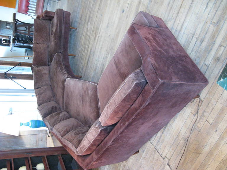 a fantastic large 1960's sectional sofa, with one curved section and one angled section. great design and wonderful proportions make this one of the best curved sectionals from this era. raised on tapered legs, in its original brown suede, which