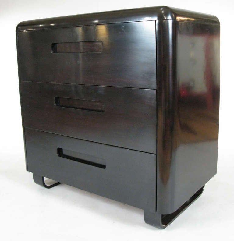 an extremely handsome pair of vintage 1940's three drawer chests designed by Paul Goldman, in an ebonized finish. beautiful & subtle design with rounded corners, the case raised on steambent birch bases. the drawers with recessed handles.