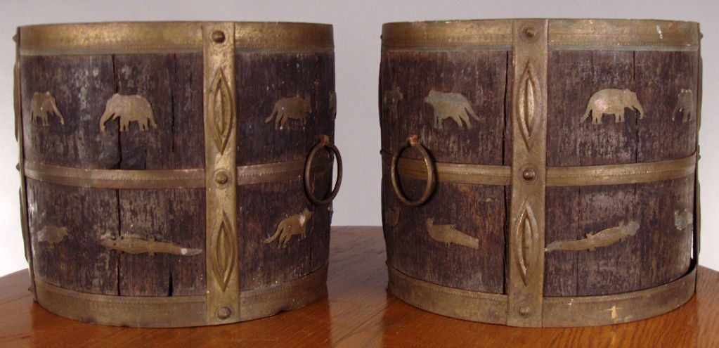 a very unique pair of antique round jardinieres in oak with hand forged brass frame and trim, as well as decorative brass animals. great details and charm.