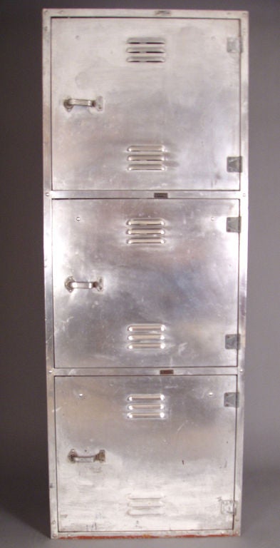 a vintage aircraft aluminum cabinet containing 3 lockers, each locking. the interiors of each are divided, and also contain a locking drawer. perfect for a variety of storage.