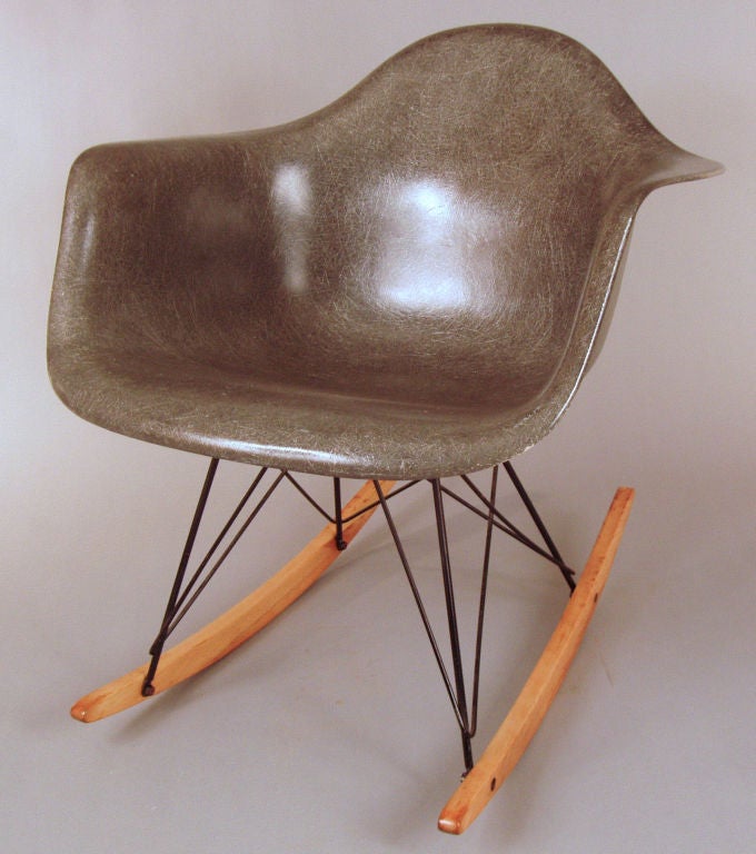 an iconic Eames for Herman Miller vintage 1957 fiberglass armshell rocking chair, mounted on a powdercoated zinc base, and birch runners. the grey shell is in excellent condition and the runners have been refinished.
