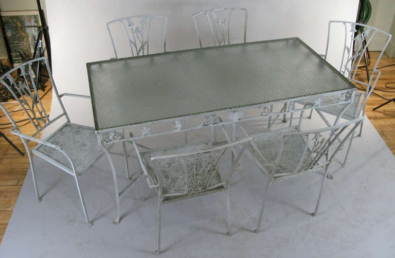 a beautiful vintage 1940's wrought iron table with a beautiful pattern of seahorses and seashells in the skirt, with its original safety glass top. together with the set of chairs that have been with it since the 40's - a set of 6 beautifully scaled