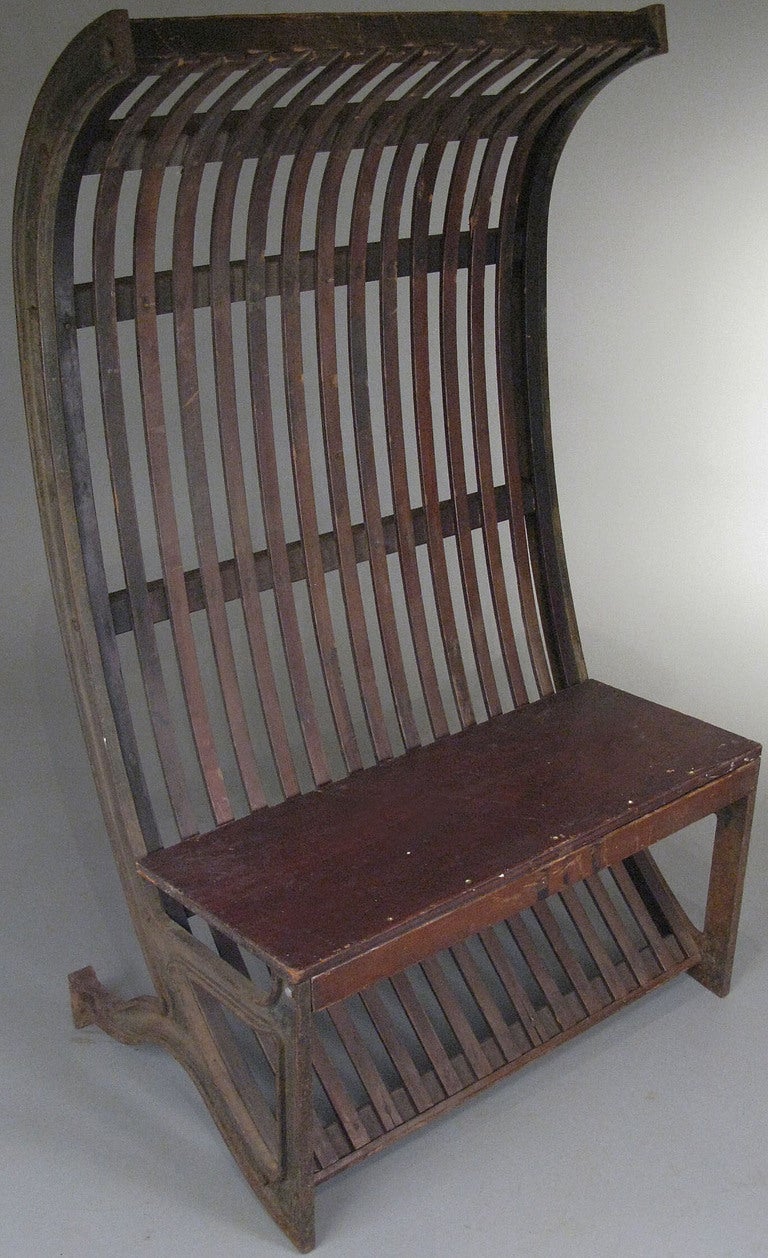 a wonderful antique industrial cast iron hooded bench, with curved and footed cast iron frame with curved oak strip back. and maple seat. fantastic industrial form.