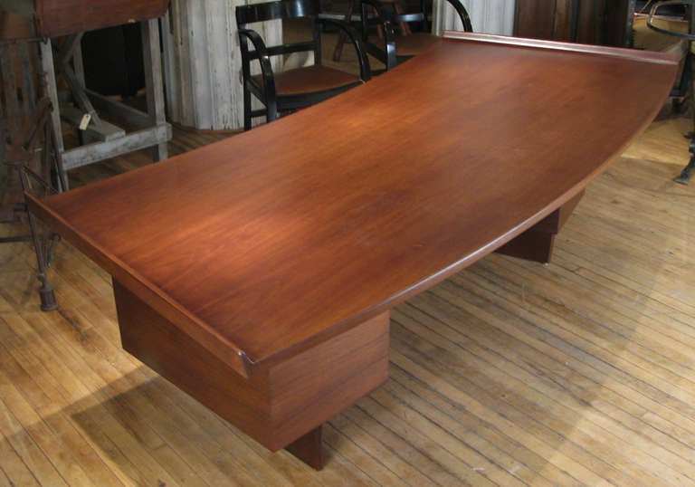 A large and impressive 1950's executive desk designed by Harvey Probber. large curved walnut surface with very nice details including raised edges on both sides and aluminum hardware. twin banks of drawers provide ample storage. retains original