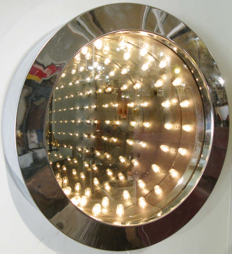 A wonderful example of Jere's iconic and classic modern Infinity mirror - this ingenious design is made with a deep chrome frame which houses a double pane mirror with a series of lights, reflected into infinity. a beautiful lighted sculptural