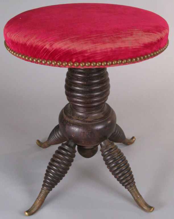 a very unusual Victorian swivel stool with a beautiful base and legs with a tapering banded design, and charming curved brass feet. all original.