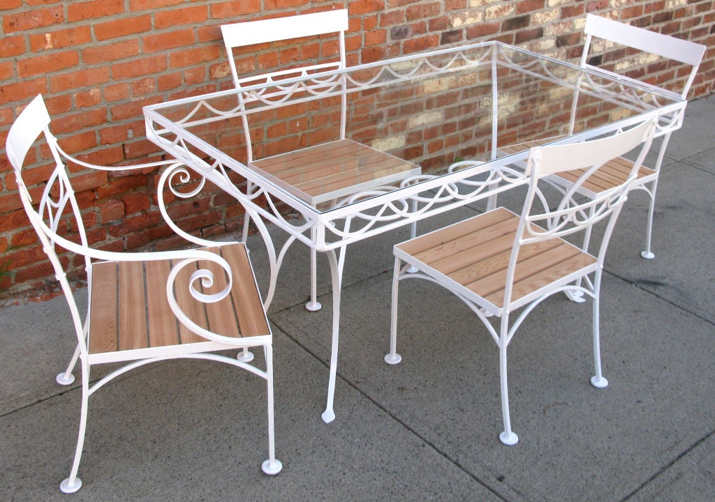 a fantastic vintage 1940's wrought iron garden table & chairs. beautiful design, the table with a swag design skirt, and gentle sweeping legs. the chairs with the same swag design and wood slat seats. one armchair with beautiful scrolled arms. all