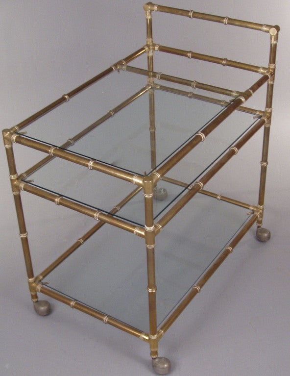 a wonderful vintage 1960's Italian Brass 'Bamboo' Bar Cart, with 3 glass shelves, the top one being a short shelf, which created a bottle well near the handle. beautiful design and very well made with a great patina. <br />
<br />
a pair