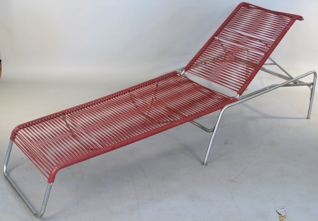A very handsome pair of vintage Mid-Century Italian adjustable chaise lounges, with tubular frames in stainless steel, and the original rubber cord seats, the backs with two levels of angle adjustment. The frames are in very good original condition,