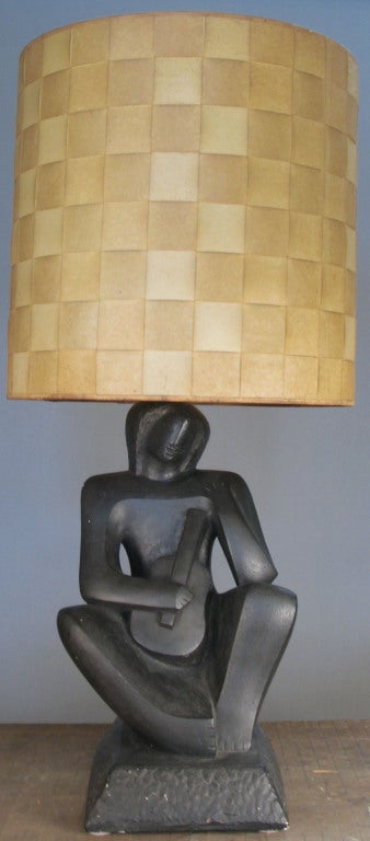a wonderful vintage 1950's lamp with a plaster base in the form of a seated figure playing the guitar. great form and scale. excellent original condition.