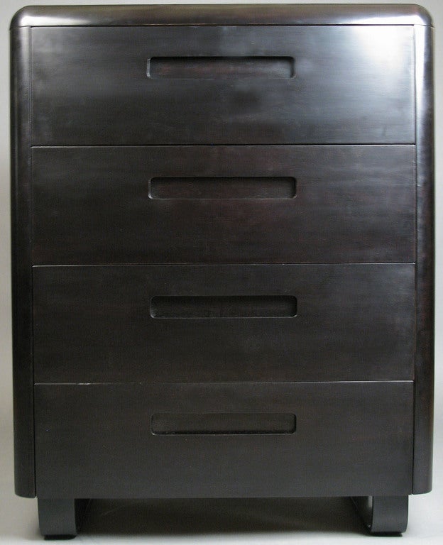 an extremely handsome vintage 1940's four drawer chest designed by Paul Goldman, in an ebonized finish. beautiful & subtle design with rounded corners, the case raised on steambent birch bases. the drawers with recessed handles.