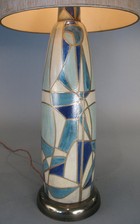 an outstanding 1950's Italian Glazed Ceramic lamp with a stunning cubist pattern in tones of ivory, pale turquoise, and royal blue, with gold outlines. amazing form and pattern and execution. rewired with double brass sockets and silk cord. shade
