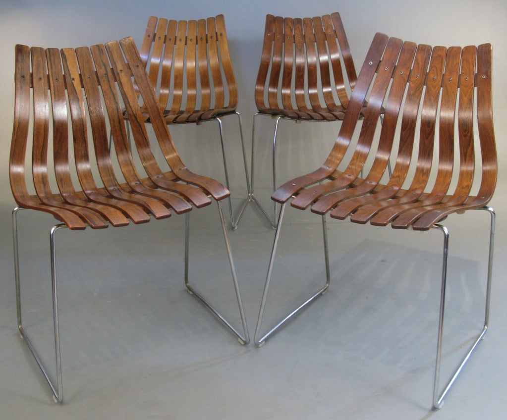 an original c. 1960 set of four Rosewood 'Scandia' dining chairs designed by Hans Brattrud and produced by Hove Mobler. beautiful and iconic design with curved bands of brazilian rosewood in a very ergonomic form supported by chromed steel base.