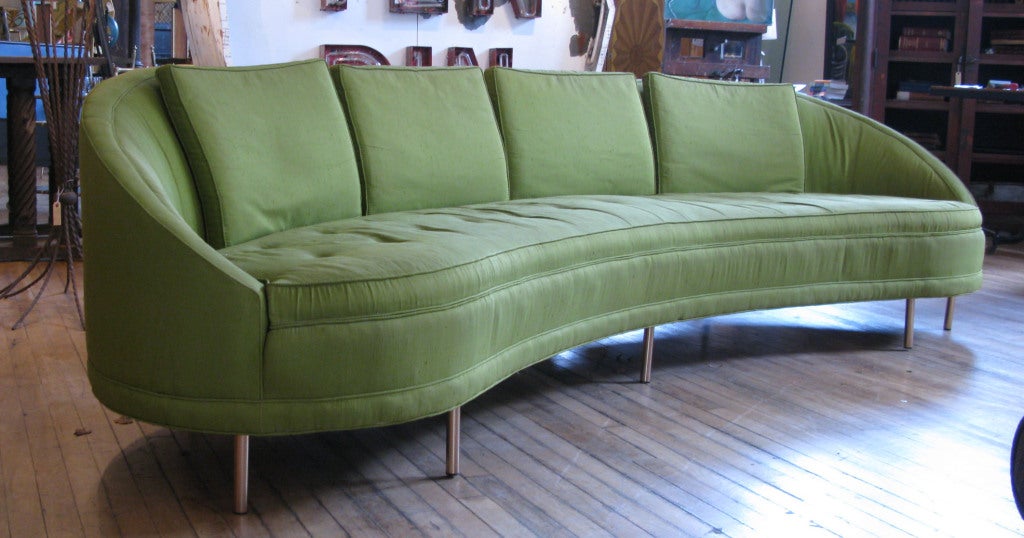 an extremely well designed, comfortable, and stylish mid-century curved sofa. amazing proportions and scale, with a beautiful curved form, raised on brass finished legs. original upholstery.