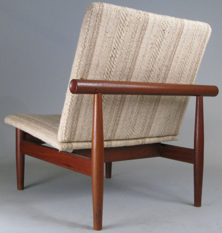 a very handsome Japan chair designed by Finn Juhl for France & Sons. frame in solid teak with brass fittings. design was inspired by the Miyajima water gate off the coast of Hiroshima.