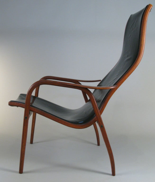 a beautiful vintage Lamino lounge chair in teak and leather designed by Yngve Ekstrom. one of the most recognizable and iconic pieces of Scandinavian furniture design, the Lamino is a sculptural classic. this example has a gorgeous teak frame and