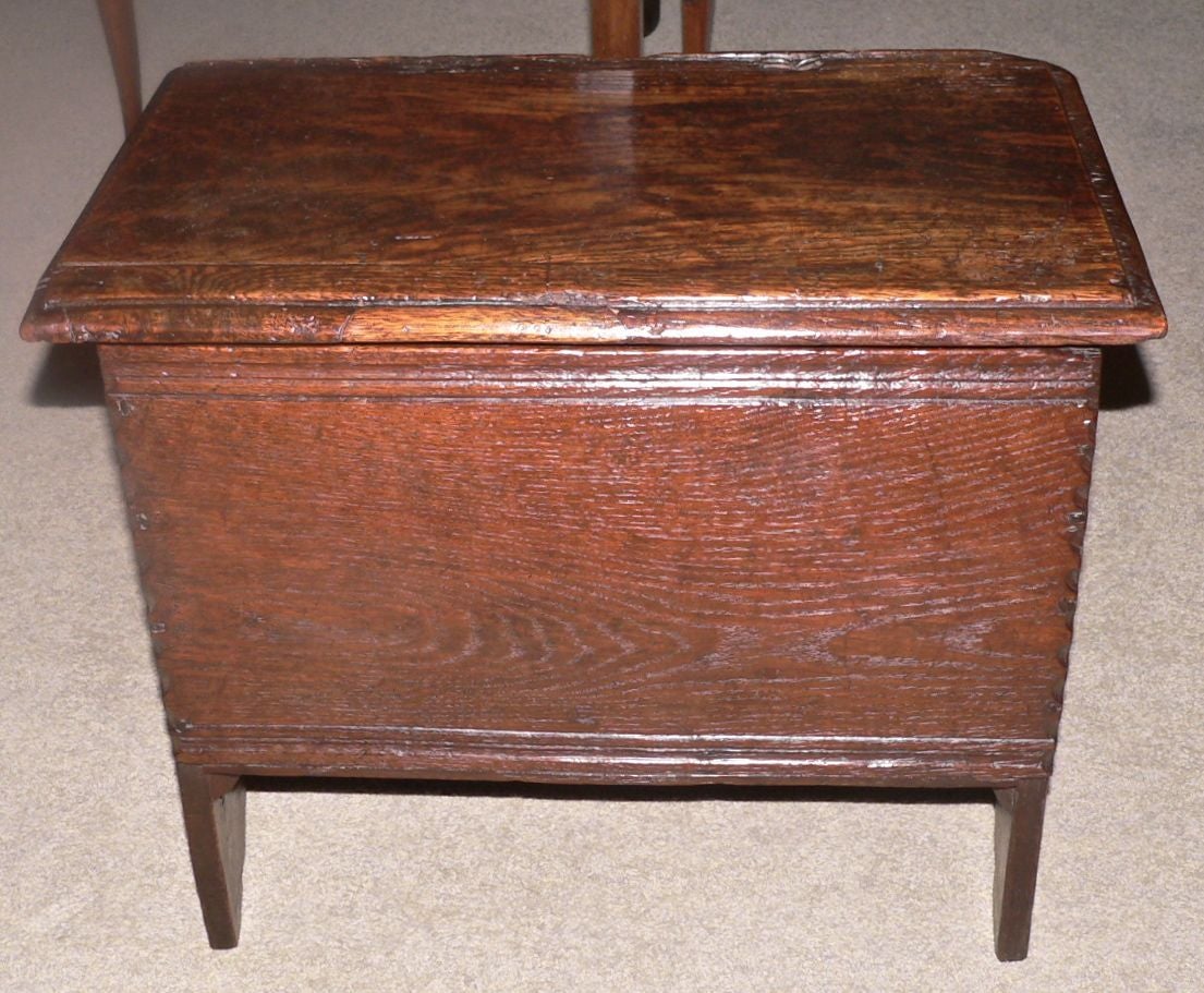 This very rare sized child's chest has a deep period oak color with great patina especially on the top. Original iron pin hinges. The interior is clean and tidy. This chest would be ideal for an end table next to a chair.