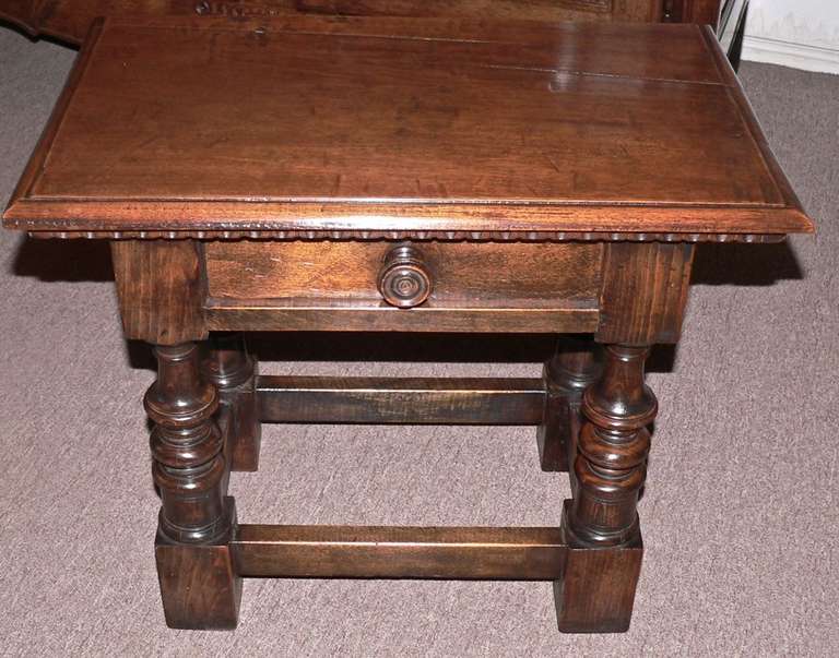 This very pretty little Spanish table would be ideal next to an armchair or sofa. It has a walnut top with a base made of pine and oak.  Very nice color on the one plank walnut top. Probably about 50 years old.