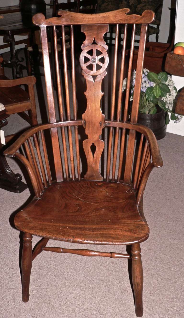 This is an excellent example of a Thames Valley comb back windsor armchair that was made between the years 1775 and 1800. It reflects the merging of both 18th and 19th century elements. It has the fretted wheel splat along with the crook arms. The
