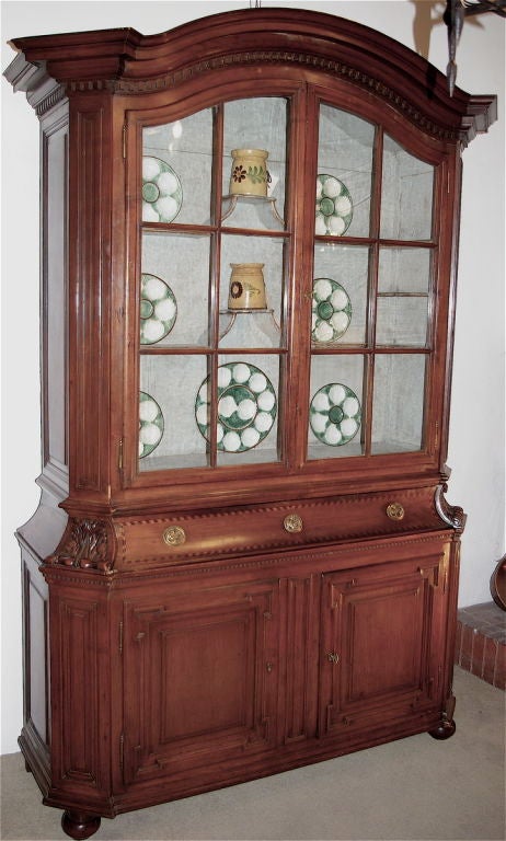 A very fine quality provencial cupboard originating from the Poitou region of Western France reflecting elements of Directoire stylings. The wood is cherry and the center drawer is inlaid with ebony and satinwood. Original cast brass birdbath