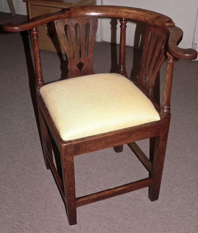 This country example of a pre Chippendale corner chair dates from about 1750 and has a wonderful color and patina. It has pierced splats with cross stretchers. The seat is attached with frabric in near perfect condition.