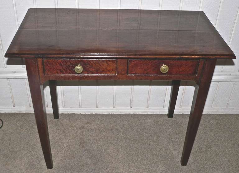 This two drawer side table has a deep oak color and a very rich patina. Excellent condition with a clean and mark free top with a moulded edge.