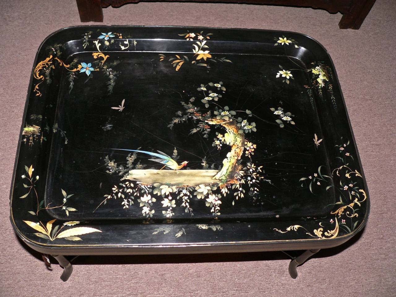 This black lacquer tray on stand was imported from England during the 1980s.
The tray is dates from about 1870 and has a bird of paradise motif. The stand was custom-made for the tray. Excellent condition.