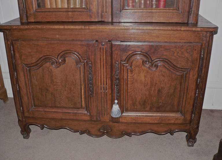 Imported into the US during the 70's, this is a very fine example of a Normandy Buffet a Deux Corps with great scale and proportion. It has a shaped bottom freize along with unrestored escargot feet. The color and patina of the oak is original and