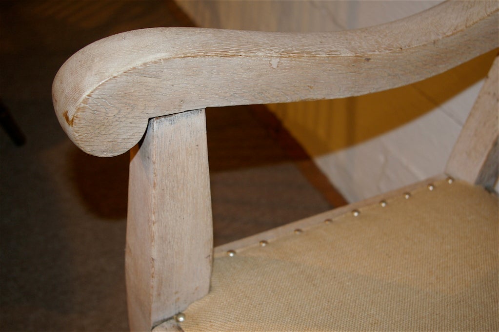 A very attractive and comfortable bench with a burlap type of covering.