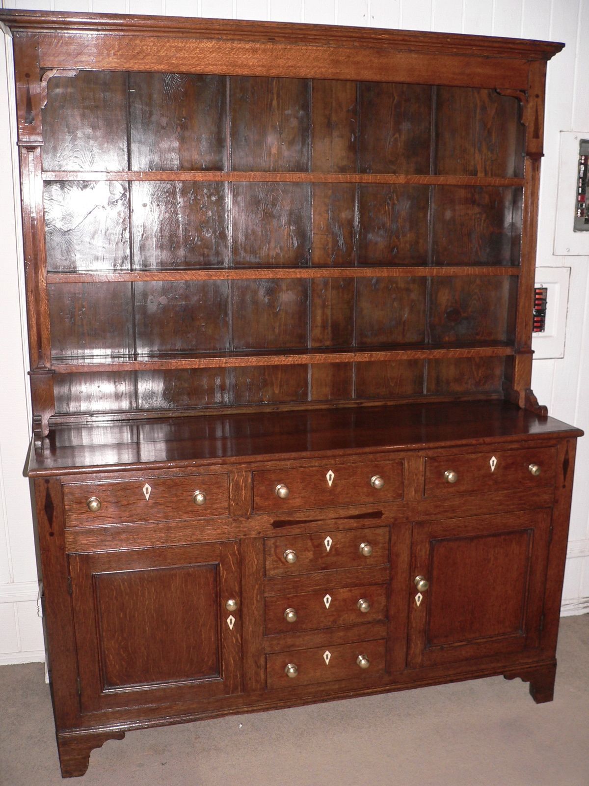 This classic North Wales dresser was made about 1850 and is in superb condition. The pine backboards are original to the dresser and the pine sides still have their original faux oak paint finish. The dresser is inlaid with ebony and has the