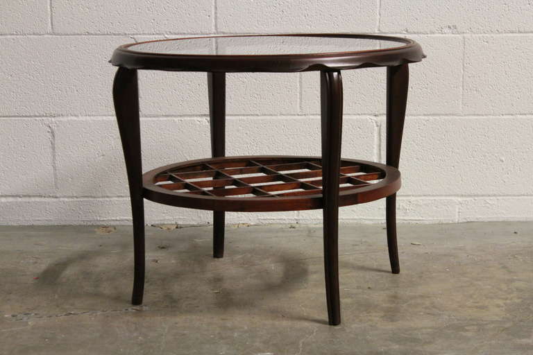 A Mahogany side table with inset glass top. Attributed to Paolo Buffa.