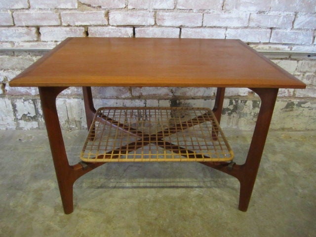 Teak table with woven cane shelf