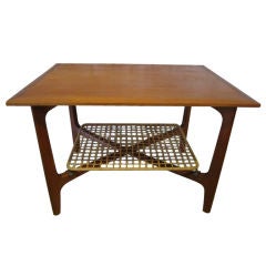 Teak table with woven cane shelf
