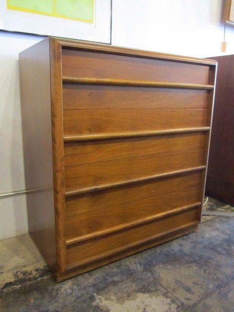 A four drawer walnut dresser designed by T.H. Robsjohn-Gibbings for Widdicomb.  If you have any questions about this item or about shipping, please contact dealer.