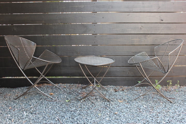 A pair of clam chairs and matching table/ottoman by Salterini.