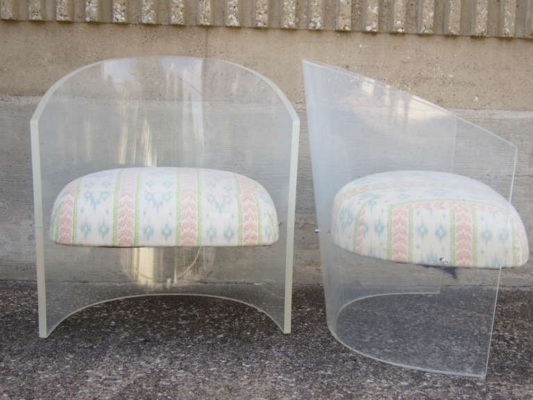 One pair of Lucite barrel back lounge chairs.