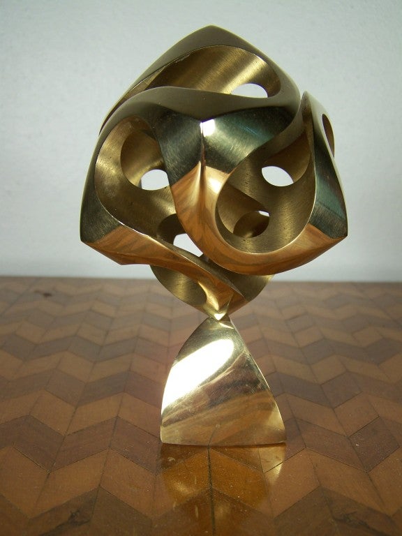 Solid brass sculpture by the late Charles O. Perry (1929-2011) titled Cassini. It is signed on the stand C.O.Perry and numbered 135/1000. The sculpture is named after Giovanni Cassini, the astronomer who contemplated that a planetary orbit may not