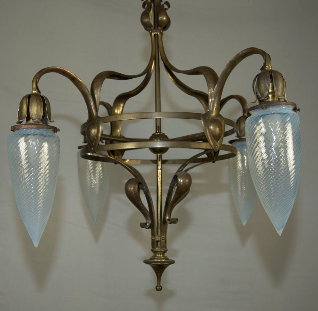 This exquisite four arm English chandelier has the beautiful grace that distinguishes the art nouveau style.  The glass shades are the best opalescent swirl torpedo shades we've seen to date.  They are large and the swirls are incredibly tight.  An