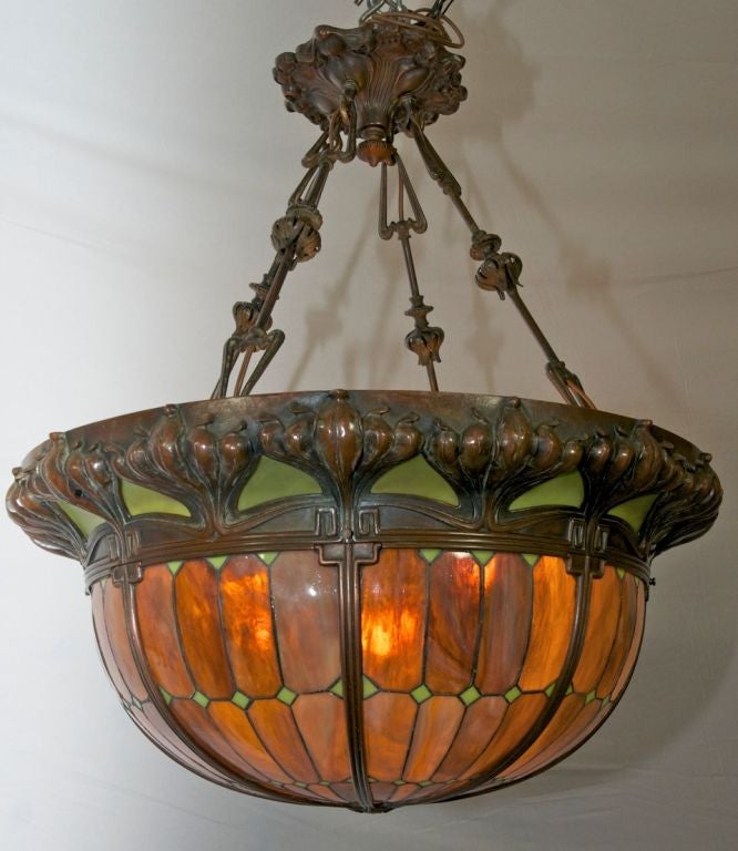 This truly is a monumental pendant chandelier.  It's hard enough to find a large pendant such as this with leaded glass, let alone in the art nouveau style.  The beautiful bent tiles are a rich, warm, yellow brown.  The green glass above it accents