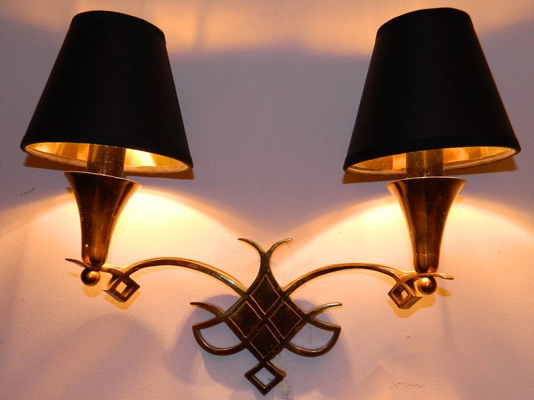 Pair of bronze French sconces coming from an apartment in Paris fully furnished with Jules Leleu furniture.
Have a look on our impressive collection of French and Italian Mid-Century period sconces. More than 100 pairs.