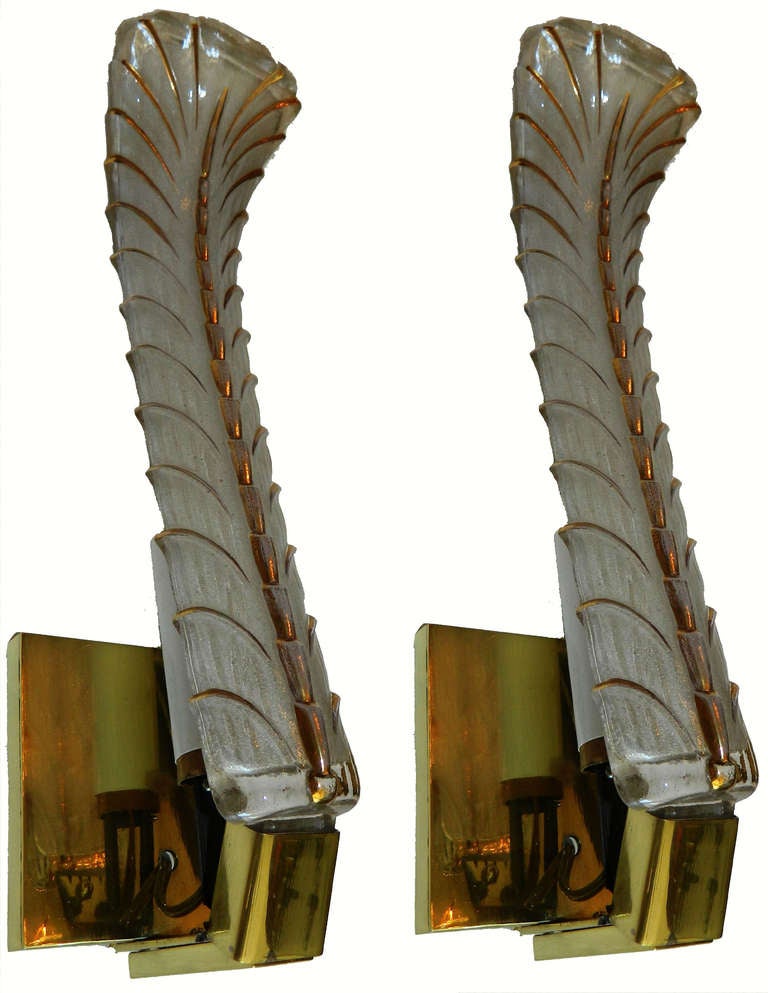 1940s Venini  Art Deco elegant and tall pair of brass Sconces with large white and gold Murano Glass Feather.
US rewired, in working condition and each Sconce takes one bulb with max. 60 watts.
3 pairs available.
Priced by pair.
Measurement : back